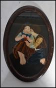 A 20th century painting on glass of a boy and girl knitting set to an oval frame. Measures 30cm