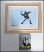 A framed and glazed Banksy Bristol street artist print Flower Bomber 6/50 along with Banksy postcard