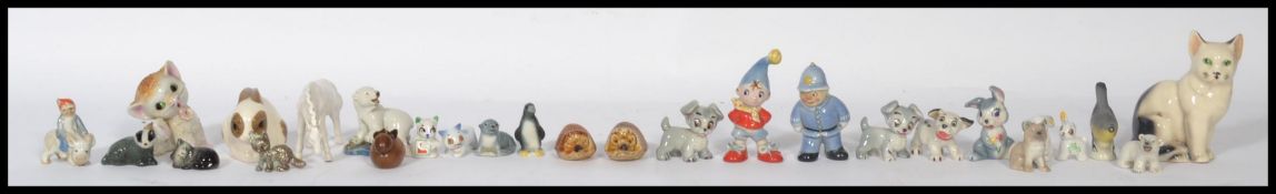 A collection of Wade Whimsie figures to include Noddy, policeman, Disney figures such as Lady,