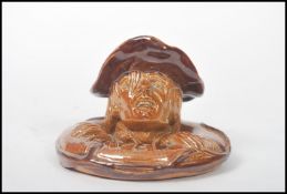 A Doulton salt glazed stone ware novelty match holder, Saved, modelled as a man holding onto a
