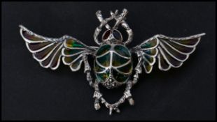 A sterling silver and plique a jour brooch in the form of a flying scarab beetle. Pin to verso.