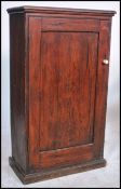 A 19th century Victorian pitch pine hall church cabinet having full length panel door enclosing