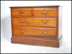 A 19th century Victorian chest of drawers having two short drawers over two long drawers raised on a