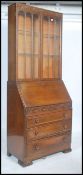 A vintage 1930's Art Deco oak bureau bookcase, with glazed upper doors, over a fall front with fully