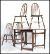 A 20th century  beech and elm Ercol drop leaf dining table together with the matching  hoop back