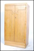 A vintage 20th century 1930's Art  Deco oak tall boy / bachelors wardrobe having carved geometric