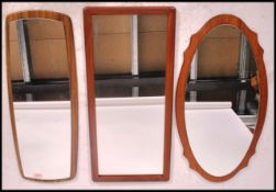 A group of three vintage 20th century retro teak mirrors. One being an frame less example.