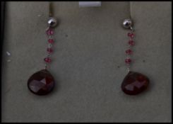 A pair of 9ct gold and garnet stone drop earrings complete in presentation box.