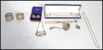 A collection of silver items to include a Victorian silver hallmarked caddy spoon strainer