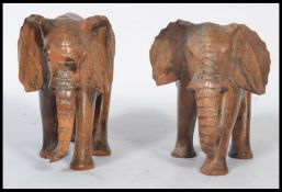A pair of early 20th century carved wooden figurines of elephants. Measures 15 cm high.