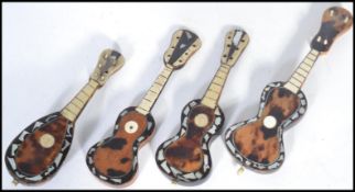 A group of four 19th century Victorian miniature mandolins and guitars. Of tortoiseshell