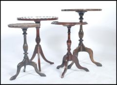 A collection of 20th century mahogany tripod wine tables each raised on splayed tripod leg bases