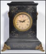 A vintage 20th century ebonised mantle clock having ormolu mounts with inset clock face. 39cm tall.