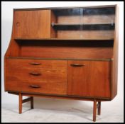 A vintage retro 20th century teak Avalon unit having sliding glass and wooden drawers. The unit