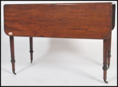 A 19th century mahogany pembroke table being raised on tapering legs with fitted frieze having end
