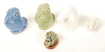 A group of Royal Doulton animals to include a pair of blue and green glazed scrolled birds , a plain