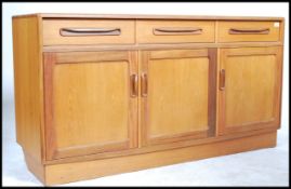 A retro 20th century G - Plan Fresco teak wood low sideboard having an arrangement of drawers and