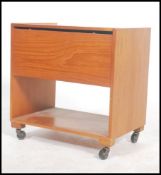A 1970's retro teak wood sewing box of pedestal form being raised on castors having hinged top