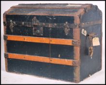 A 19th century Victorian dome top trunk having hinged top being ebonised canvas and wooden bound