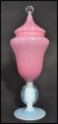 A 20th century Venetian glass lidded vase having an opalescent circular foot with pink swirl body