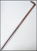 A 19th century Victorian walking stick cane having a tapering wooden shaft with shaped handle. The