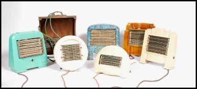 A collection of 7 vintage 20th century enamel heaters. Of varying designs and colourways to
