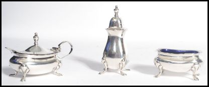 A silver hallmarked silver condiment set comprising of a pepperpot , mustard and salt pots with