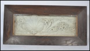A section of an Elizabethan plaster cornice depicting shell and leaf held within a glazed case.