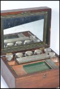 A 19th century Victorian mahogany cased travelling vanity nessasaire. The hinged lid opening to