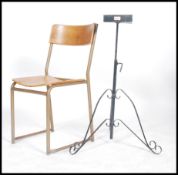 A single vintage mid 20th century tubular framed panel seat stacking chair together with a wrought