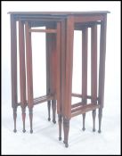 An early 20th century Edwardian inlaid mahogany trio nest of tables raised on squared legs and