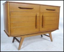 A retro mid century sideboard having short drawers over twin door cupboard and raised on tapering