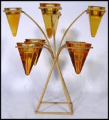 A 20th century candelabra painted metal candle holder having 8 conical glass cups on a splayed