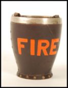A Doulton Leatherware silver hallmarked rimmed fire bucket with notation to front. Impressed marks