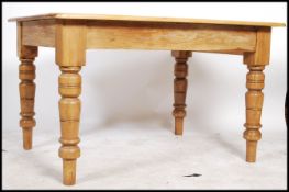 A 20th century pine dining table having a square top and rounded edges, the frieze having a single