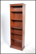 A 20th century Georgian revival open front tall mahogany bookcase, fitted with a series of
