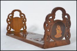 A 19th century olive / fruit wood book trough of metamorphic form. The slide out carved pierced