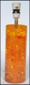 A retro vintage mid 20th century Shatterline amber type resin lamp base in orange colourway.
