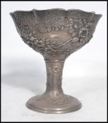 An unusual Chinese silver foil overlaid white metal pedestal bowl. The bowl with foil silver