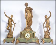 A 19th century clock and garniture set raised on green marble bases with ormolu detailing. The