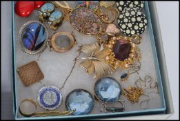 A collection of costume jewellery to include compact , purse , necklaces , bracelets , brooches ,