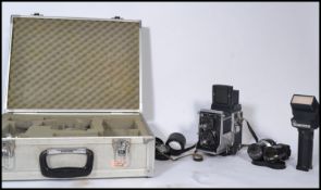 A vintage 20th century Mamiya C3 twin lens Professional Camera with additional items contained