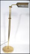 A vintage 20th century floor standing anglepoise brass bankers lamp having an adjustable shade