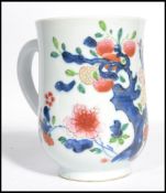 An 18th century Chinese porcelain tankard having hand painted poly - chrome decoration depicting