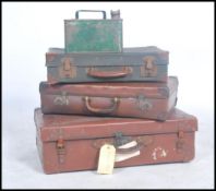 A stack of vintage 20th century suitcases together with a mid century fuel / petrol can.