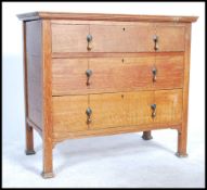 An early 20th century Edwardian Arts & Crafts solid  oak chest of drawers hjaving three long drawers