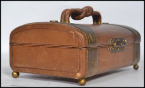 A vintage mid 20th century leather and brass bound jewellery box / casket, hinged lid raised on ball