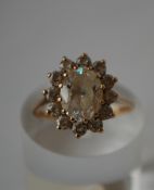 A hallmarked 9ct gold cluster ring set with a central white stone surrounded by a white stone