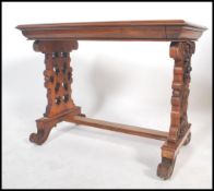 A  good 19th century Victorian walnut writing table desk being raised on pierced column supports