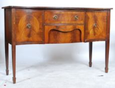 A Georgian revival mahogany bow front mahogany inlaid sideboard being raised on squared tapering